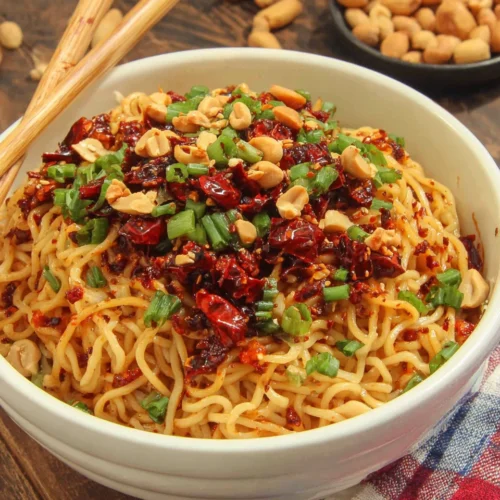 Chili Crisp Noodles: A Flavorful Weeknight Delight 1 Chili crisp noodles garnished with peanuts and green onions.