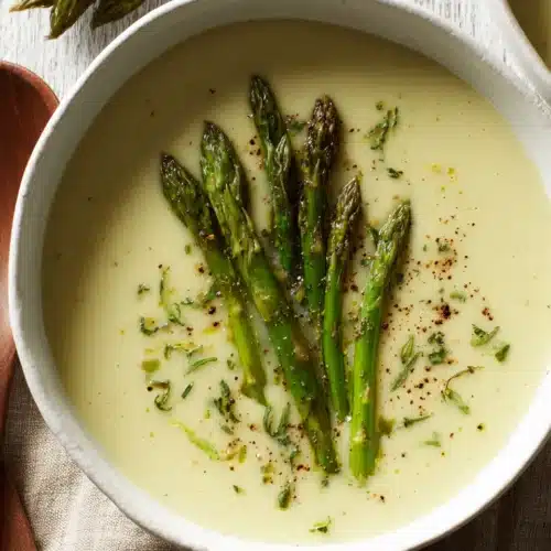 Cream of Asparagus Soup: A Delightfully Creamy Treat 1 Cream of asparagus soup with fresh asparagus spears.