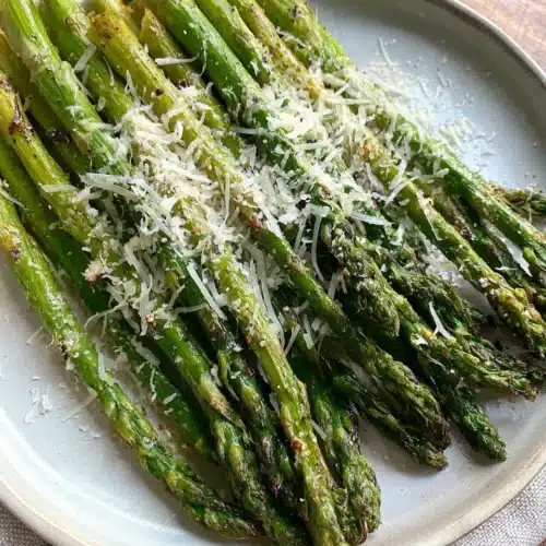 Oven Roasted Garlic Parmesan Asparagus: A Delicious Side Dish 1 Oven roasted garlic parmesan asparagus on plate.