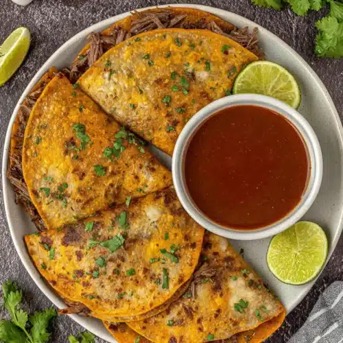 Birria Consome Sauce: A Savory Delight for Weeknight Dinners 1 Birria consome sauce and tacos for a delightful meal.