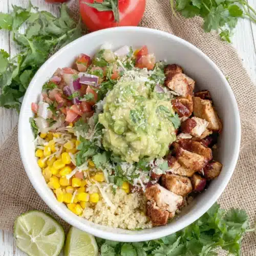 Delicious Chipotle Chicken Bowl for a Family Feast 1 Chipotle chicken bowl with vibrant fresh toppings and cilantro lime rice.