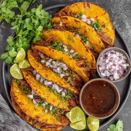Crock Pot Birria Tacos: A Flavorful Delight 1 Delicious crock pot birria tacos served with garnishes.