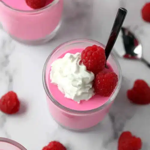 Delicious Greek Yogurt Jello Cups: A Simple Treat 1 Greek yogurt jello cups with raspberries and whipped cream in glass jars
