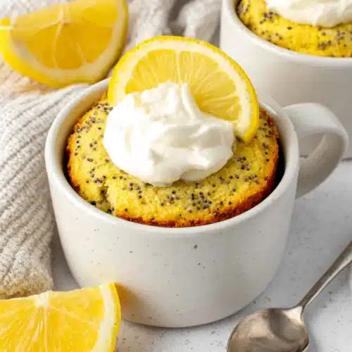 Lemon Poppy Seed Mug Cake: A Refreshing Delight 1 Lemon poppy seed mug cake topped with cream.