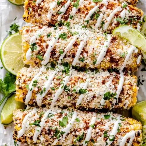 Mexican street corn (elote) topped with cheese and spices.