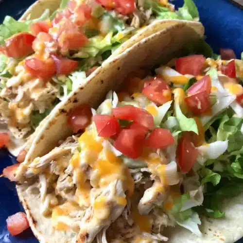 Creamy slow cooker queso chicken tacos with fresh toppings