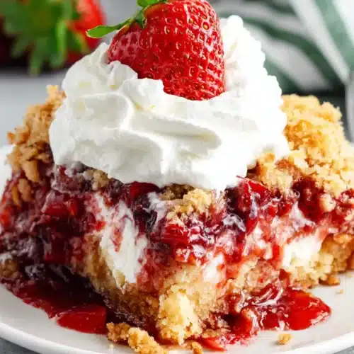 Delicious Strawberry Dump Cake Recipe You Must Try 1 Strawberry dump cake slice with whipped cream and fresh strawberry on top