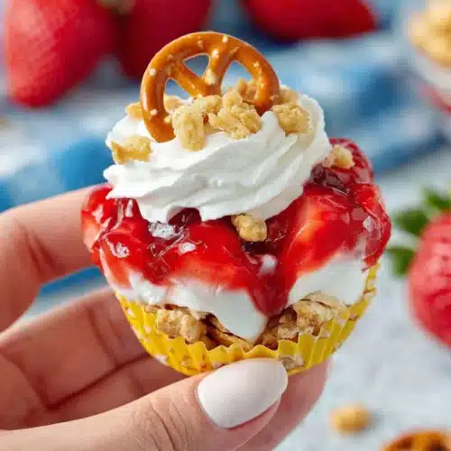 Delicious Walking Strawberry Pretzel Salad: A Fun Treat 1 Walking strawberry pretzel salad in a mini pretzel bag with strawberry topping and whipped cream