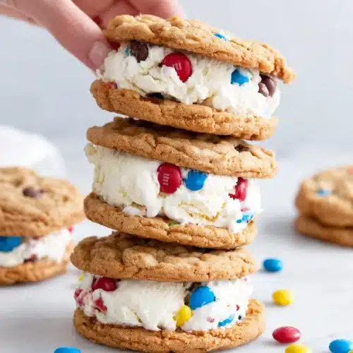 Delicious 4th of July Cookies with M&Ms for Everyone 1 4th of July cookies with M&Ms stacked as ice cream sandwiches, featuring red, white, and blue candies.