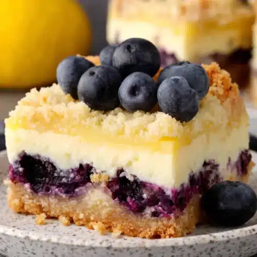 Blueberry Lemon Pie Bars: A Delightfully Tangy Treat 1 Blueberry lemon pie bars with fresh blueberries and lemon zest, served on a plate