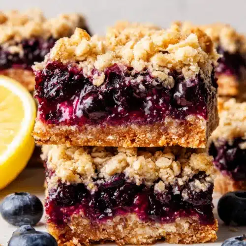 Blueberry Oatmeal Bars: A Deliciously Easy Snack 1 Blueberry oatmeal bars with crumble topping and fresh blueberries