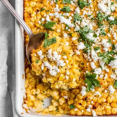 Corn Casserole: A Delightfully Easy Comfort Food 1 Creamy corn casserole with queso fresco and cilantro in a white dish