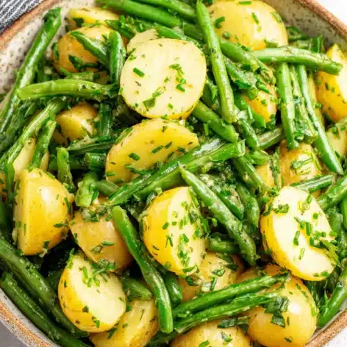 Creamy Green Bean Potato Salad: A Delightful Side Dish 1 Creamy green bean potato salad with fresh herbs in a ceramic bowl