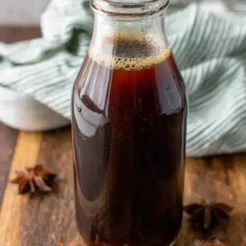 Easy Chai Concentrate Recipe: A Warm Delight 1 Easy chai concentrate in glass bottle with star anise on wooden table
