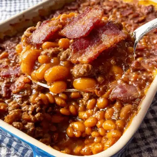 Easy southern baked beans with ground beef and bacon in a blue dish