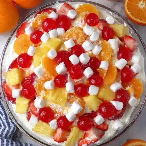 Fruit Salad with Cool Whip: A Delightfully Easy Treat 1 Colorful fruit salad with Cool Whip, strawberries, oranges, cherries, and marshmallows in a glass bowl