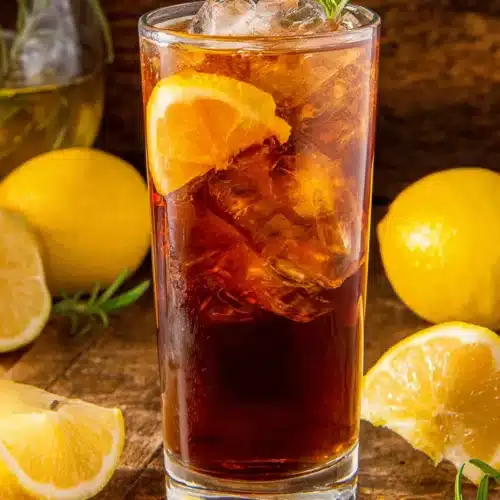 Homemade Lemon Sweet Tea: Refreshingly Delicious and Easy 1 Homemade lemon sweet tea with ice, lemon slice, and rosemary garnish