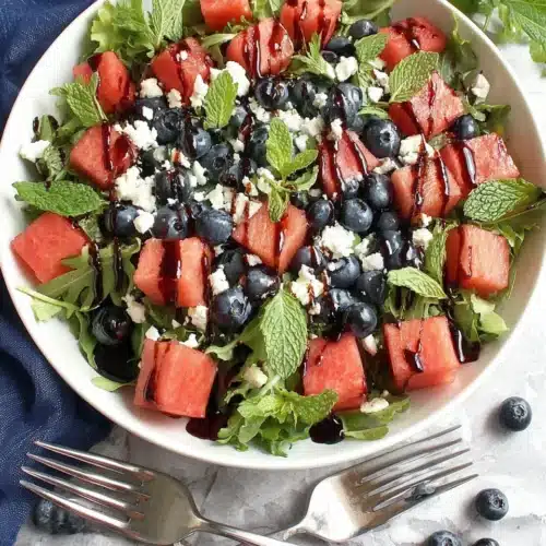 July 4th Salad: A Delightfully Refreshing Treat 1 July 4th salad with watermelon, blueberries, feta, and mint in a white bowl