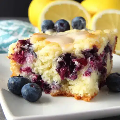 Lemon Blueberry Breakfast Cake: A Delightful Treat 1 Lemon blueberry breakfast cake slice with fresh blueberries and lemon halves