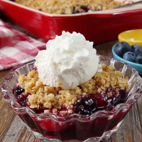 Mini Blueberry Crisp: A Delightful Treat for Everyone 1 Mini blueberry crisp in a glass dish with whipped cream