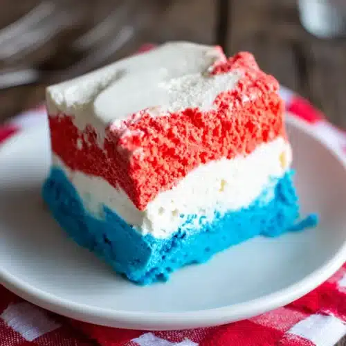 Delicious Patriotic Neapolitan Ice Cream for Celebrations 1 Patriotic Neapolitan ice cream slice with red, white, and blue layers on a plate