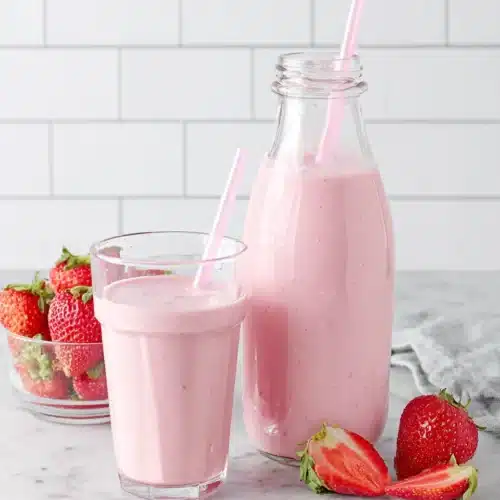 Delicious Strawberry Smoothie Recipe with Yogurt 1 Strawberry smoothie with yogurt in glasses and bottle, fresh strawberries nearby