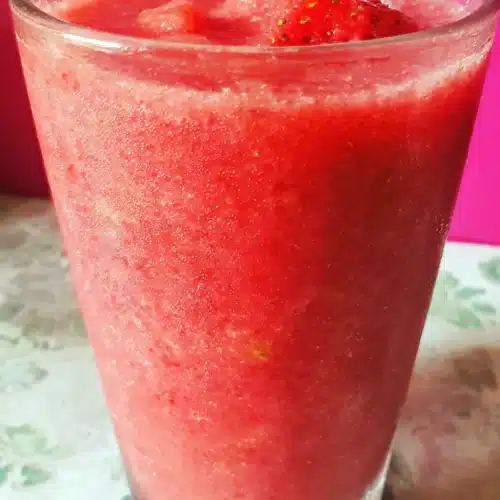 Strawberry Smoothie Surprise: A Delightful Treat 1 Strawberry smoothie surprise in a glass with condensation, pink background