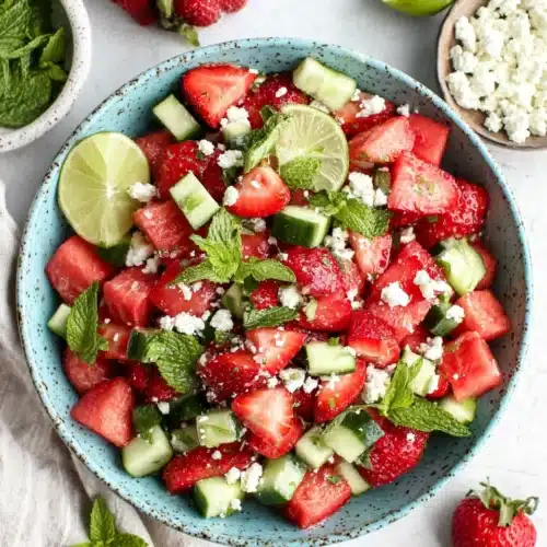 Refreshing Strawberry Watermelon Cucumber Salad for Summer 1 Strawberry watermelon cucumber salad with feta and mint in a ceramic bowl