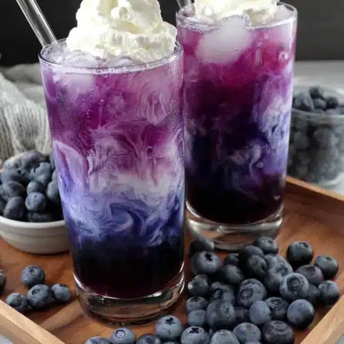 Sugar Free Blueberry Italian Cream Soda: Refreshingly Delicious! 1 Sugar free blueberry italian cream soda in tall glasses with whipped cream and fresh blueberries