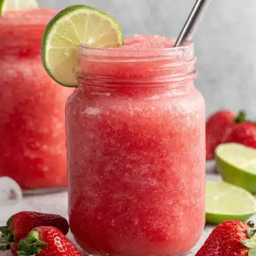 Watermelon and Strawberry Slushie: Refreshing and Fun! 1 Watermelon and strawberry slushie in a glass jar with lime garnish