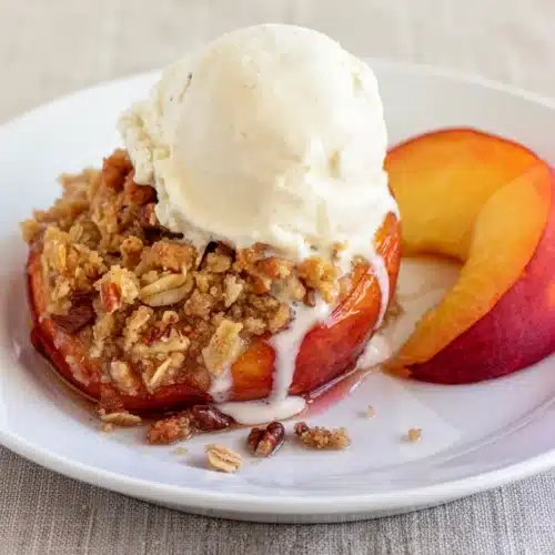 Baked Peaches with Brown Sugar Streusel: An Indulgent Delight 2 Baked peaches with brown sugar streusel topped with vanilla ice cream