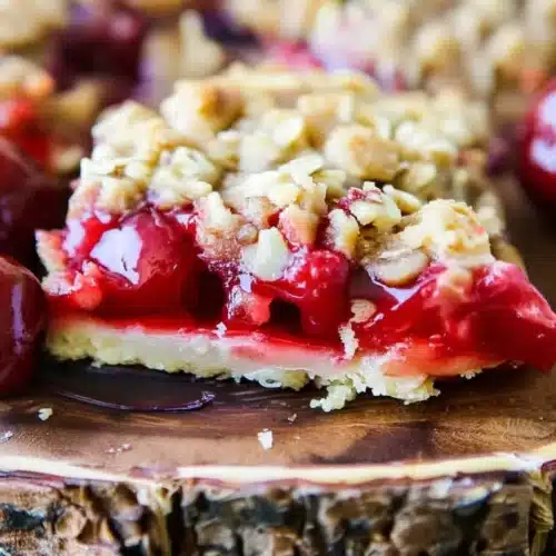 Cherry Crisp Bars Mashup: A Delightful Treat 1 Cherry crisp bars mashup with juicy cherries and crunchy oat topping on wooden board