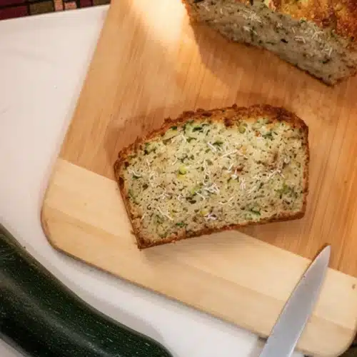 Coconut Flour Zucchini Bread: Delicious and Healthy! 2 Coconut flour zucchini bread slice on wooden board with fresh zucchini