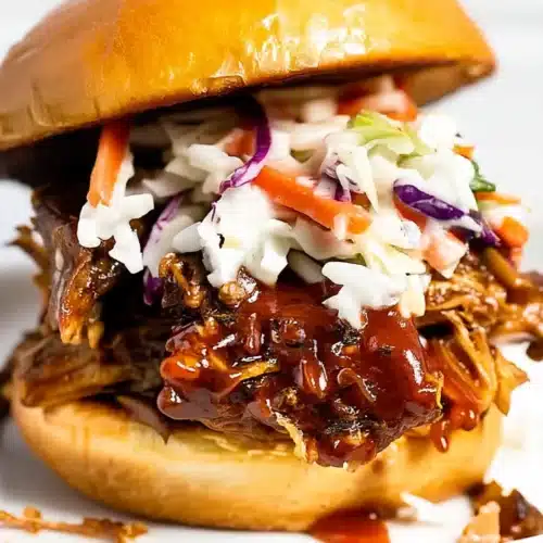 Easy Instant Pot BBQ Pulled Pork Burger: A Savory Delight 1 Easy instant pot BBQ pulled pork burger with coleslaw on a brioche bun