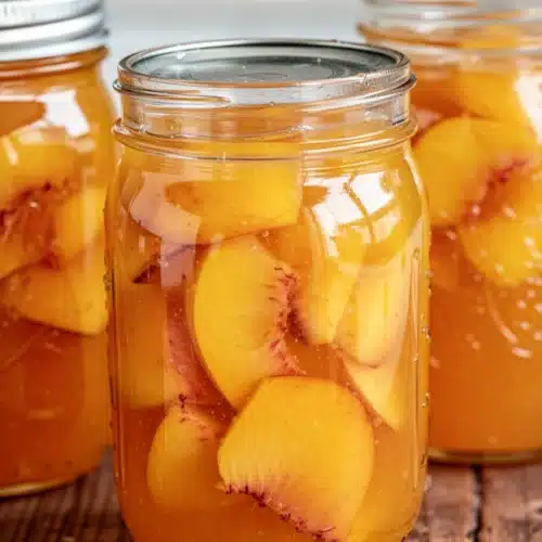 Fresh Peach Jam: A Deliciously Simple Treat 2 Jars of fresh peach jam with golden lids, glowing with summer sweetness