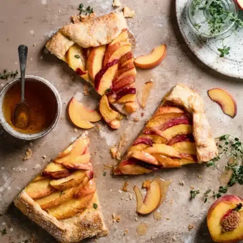 Delicious Galette with Peach Slices: A Sweet Treat 2 Slices of galette with peach slices on a rustic surface with honey and herbs