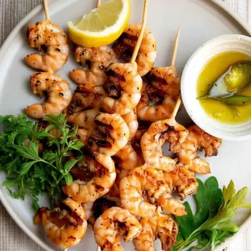 Garlic Shrimp Skewers: A Deliciously Simple Delight 1 Grilled garlic shrimp skewers with lemon and herbs on a plate