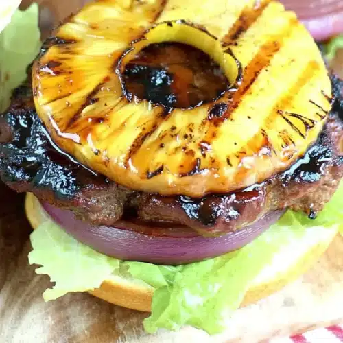Grilled Teriyaki Burger: A Savory Delight for Dinner 1 Grilled teriyaki burger with pineapple and red onion on a toasted bun