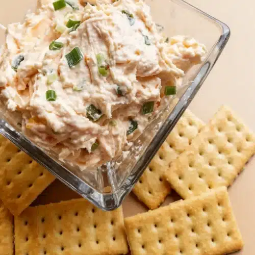 Jalapeno Peach Dip: A Sweet and Spicy Delight 2 Jalapeno peach dip in a glass bowl with crackers