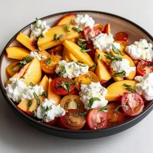 Delicious Peach Burrata Salad with Champagne Vinaigrette 2 Peach burrata salad with champagne vinaigrette, fresh peaches, tomatoes, and basil
