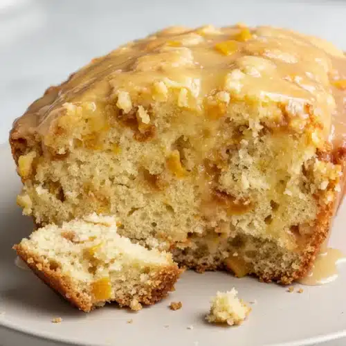 Delicious Peach Cobbler Bread: A Sweet Delight 2 Moist peach cobbler bread with white chocolate glaze, showcasing juicy peaches and fluffy texture