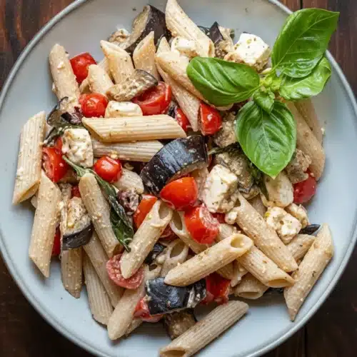 Quick Summer Pasta with Eggplant, Tomato, and Feta: A Delightful Dish 2 Quick summer pasta with eggplant, tomato, and feta on a plate with fresh basil