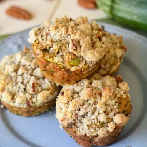 Zucchini Coffee Cake Muffins: A Deliciously Moist Delight 2 Zucchini coffee cake muffins with crumb topping on a plate