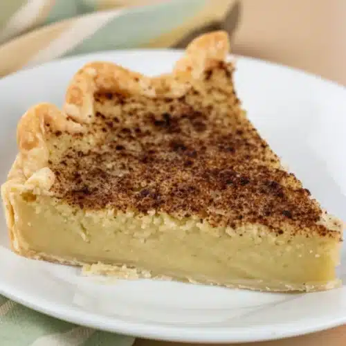 Zucchini Pie: A Delightfully Sweet Dessert 2 A slice of zucchini pie with a golden crust and cinnamon topping on a white plate