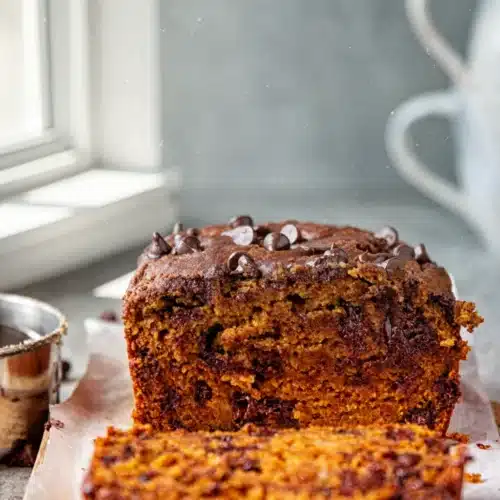 The Best Chocolate Chip Pumpkin Bread: A Cozy Delight 1 Moist best chocolate chip pumpkin bread with chocolate chips, sliced on parchment paper