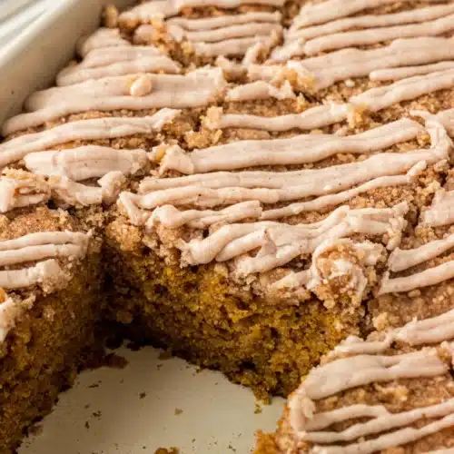 Cinnamon Streusel Pumpkin Cake: An Irresistibly Moist Delight 1 Moist cinnamon streusel pumpkin cake with crumbly topping and white icing drizzle